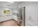 Bright kitchen featuring white cabinets, stainless steel fridge, and wood floors, creating an inviting cooking space at 26 W Morten Ave, Phoenix, AZ 85021