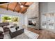 Comfortable living room featuring a stone fireplace, wood ceiling, and stylish furnishings at 26 W Morten Ave, Phoenix, AZ 85021