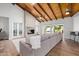 Cozy living room features a stone fireplace, wood ceiling, and ample natural light at 26 W Morten Ave, Phoenix, AZ 85021