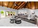 Bright living room with a beamed ceiling, modern decor, and seamless access to outdoor space at 26 W Morten Ave, Phoenix, AZ 85021