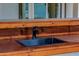 Close-up of an outdoor sink with a wooden countertop and modern black faucet at 26 W Morten Ave, Phoenix, AZ 85021