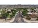 A beautiful aerial view of homes and a street with a palm tree in a desert neighborhood with mountain views at 2627 E Gary Way, Phoenix, AZ 85042