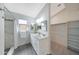 Clean bathroom with double vanity sink, walk-in shower with stone tile, next to walk-in closet at 2627 E Gary Way, Phoenix, AZ 85042