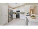 Modern kitchen featuring stainless steel appliances, white cabinetry, and quartz countertops at 2627 E Gary Way, Phoenix, AZ 85042