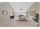Open-concept living room with high ceilings, ceiling fan, lots of natural light, and access to other rooms at 2627 E Gary Way, Phoenix, AZ 85042