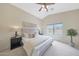 Serene main bedroom with neutral tones, a ceiling fan, and a view of the pool at 2627 E Gary Way, Phoenix, AZ 85042
