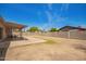 Expansive backyard with patio, block wall and some mature trees beyond at 2826 E Cactus Rd, Phoenix, AZ 85032