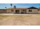 View of the home's backyard with patio and partial privacy wall at 2826 E Cactus Rd, Phoenix, AZ 85032