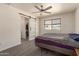 Bright bedroom featuring modern ceiling fan, sleek sliding closet door and neutral decor at 2826 E Cactus Rd, Phoenix, AZ 85032