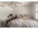 Spacious bedroom featuring a workstation, comfortable bed, and modern ceiling fan at 2826 E Cactus Rd, Phoenix, AZ 85032
