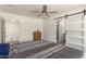 Comfortable bedroom with ceiling fan and access to the bathroom and closet at 2826 E Cactus Rd, Phoenix, AZ 85032