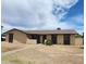 Charming single-story home featuring neutral stucco, dark trim accents, and a well-defined walkway leading to the front door at 2826 E Cactus Rd, Phoenix, AZ 85032