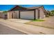 Attached two-car garage featuring a white door and modern architectural details at 2826 E Cactus Rd, Phoenix, AZ 85032
