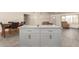Stylish kitchen island featuring a marble countertop and white cabinetry at 2826 E Cactus Rd, Phoenix, AZ 85032
