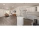 Open-concept living room flowing into the kitchen, featuring modern gray floors and ample natural light at 2826 E Cactus Rd, Phoenix, AZ 85032