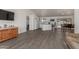 Open-concept living room featuring modern gray flooring and flowing access to the kitchen and dining area at 2826 E Cactus Rd, Phoenix, AZ 85032