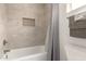 Clean, tiled bathroom tub and shower combination at 2826 E Cactus Rd, Phoenix, AZ 85032