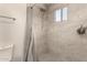 Detailed view of bathroom shower with gray tiling and modern showerhead at 2826 E Cactus Rd, Phoenix, AZ 85032