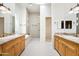 Dual sink bathroom featuring custom cabinets, granite countertops, and a standalone shower at 316 E Bethany Home Rd, Phoenix, AZ 85012