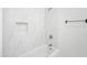Bathroom with shower and tub features stone-look tile surround at 316 E Bethany Home Rd, Phoenix, AZ 85012