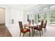 Bright dining room with large windows overlooking the backyard, with light carpet and dark wood trim at 316 E Bethany Home Rd, Phoenix, AZ 85012