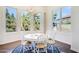 Bright dining room with a chandelier and large windows with a view of trees at 316 E Bethany Home Rd, Phoenix, AZ 85012