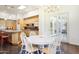 Bright dining area with a round table, white chairs and sliding doors to a patio area at 316 E Bethany Home Rd, Phoenix, AZ 85012