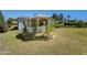Quaint covered gazebo in yard surrounded by grass and landscaping at 316 E Bethany Home Rd, Phoenix, AZ 85012