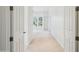 Bright hallway with tan carpet, white walls, and doors on either side at 316 E Bethany Home Rd, Phoenix, AZ 85012