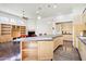 Open-concept kitchen with island, countertop seating, and modern appliances at 316 E Bethany Home Rd, Phoenix, AZ 85012