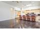 Open-concept kitchen with stainless steel appliances, dark hardwood floors, and counter seating for four at 316 E Bethany Home Rd, Phoenix, AZ 85012