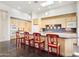 Bright kitchen with island and seating, stainless appliances, skylight, and stone countertops at 316 E Bethany Home Rd, Phoenix, AZ 85012