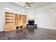 Spacious living room featuring built-in shelving, fireplace, and dark hardwood floors at 316 E Bethany Home Rd, Phoenix, AZ 85012