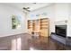 Bright living room with a fireplace and a built in entertainment center and gleaming hardwood floors at 316 E Bethany Home Rd, Phoenix, AZ 85012