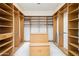 Spacious walk-in closet with custom shelving, drawers, and center island at 316 E Bethany Home Rd, Phoenix, AZ 85012
