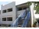 Apartment building exterior with blue stairs leading to the second floor entrance at 3301 E Earll Dr # 219, Phoenix, AZ 85018