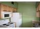 A compact kitchen featuring standard appliances and light wood cabinets, ready for customization at 3301 E Earll Dr # 219, Phoenix, AZ 85018