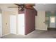 An interior view with neutral walls, a ceiling fan, and access to the kitchen area at 3301 E Earll Dr # 219, Phoenix, AZ 85018