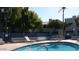 Pool area with lounge chairs, mature trees, and a relaxing vacation vibe at 3301 E Earll Dr # 219, Phoenix, AZ 85018
