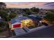 Gorgeous twilight aerial view showcasing this updated home with a red garage door and inviting outdoor spaces at 3429 E Coolidge St, Phoenix, AZ 85018