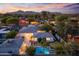 Beautiful backyard with pool, lush landscaping, and mountain views from this stunning aerial shot at 3429 E Coolidge St, Phoenix, AZ 85018
