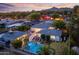 Aerial view featuring an inviting pool, outdoor lounge area, and manicured landscaping at 3429 E Coolidge St, Phoenix, AZ 85018