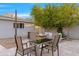 Relaxing backyard featuring an outdoor dining area and comfortable seating around a cozy fire pit at 3429 E Coolidge St, Phoenix, AZ 85018