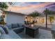 Inviting backyard oasis featuring a cozy fire pit and stylish patio furniture under a vibrant sunset sky at 3429 E Coolidge St, Phoenix, AZ 85018