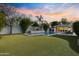 Luxurious backyard with pool, putting green, and lush landscaping at 3429 E Coolidge St, Phoenix, AZ 85018