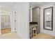Bright bathroom featuring walk-in closet, vanity area, and tiled floors at 3429 E Coolidge St, Phoenix, AZ 85018