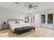 Bright main bedroom features a comfortable king-sized bed and access to a private outdoor space at 3429 E Coolidge St, Phoenix, AZ 85018