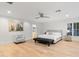Spacious main bedroom featuring a comfortable king-sized bed and ample natural light with wood floors at 3429 E Coolidge St, Phoenix, AZ 85018