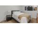 Inviting bedroom with hardwood floors, window, cozy blanket, and nightstand with lamp at 3429 E Coolidge St, Phoenix, AZ 85018