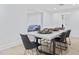 Contemporary dining room flows into the living room with neutral decor and modern chairs at 3429 E Coolidge St, Phoenix, AZ 85018